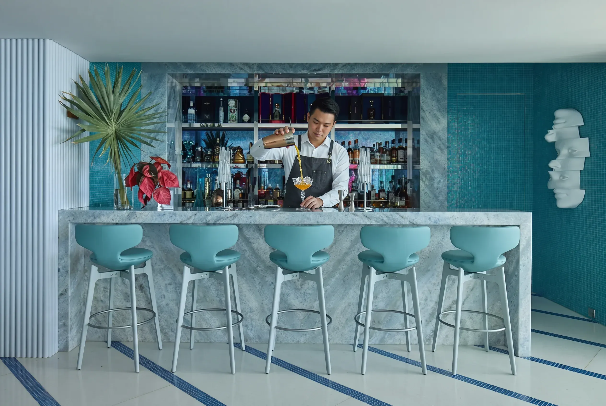 The estate's mixologist at the marble bar of the Party House