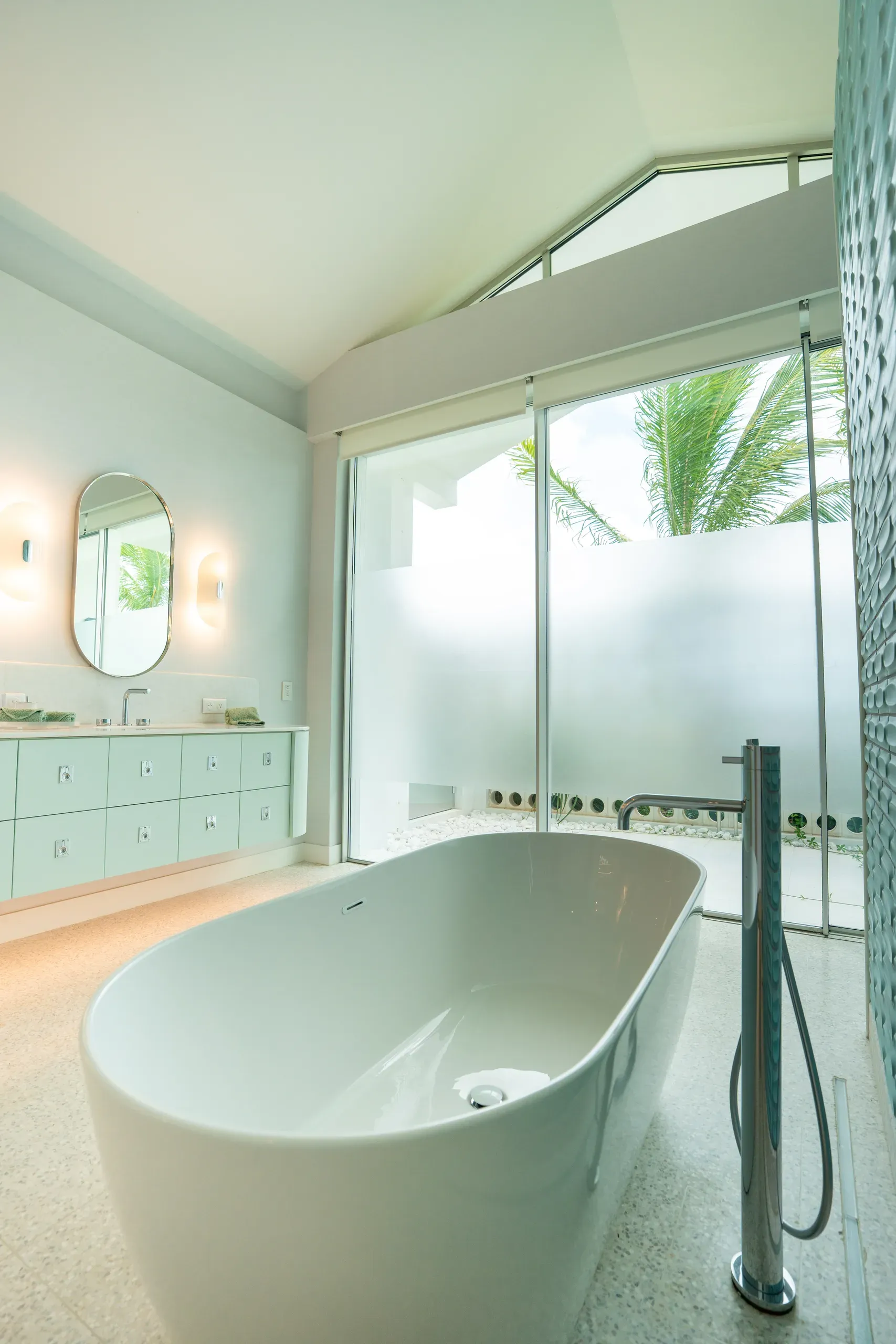 A freestanding tub beside the private patio