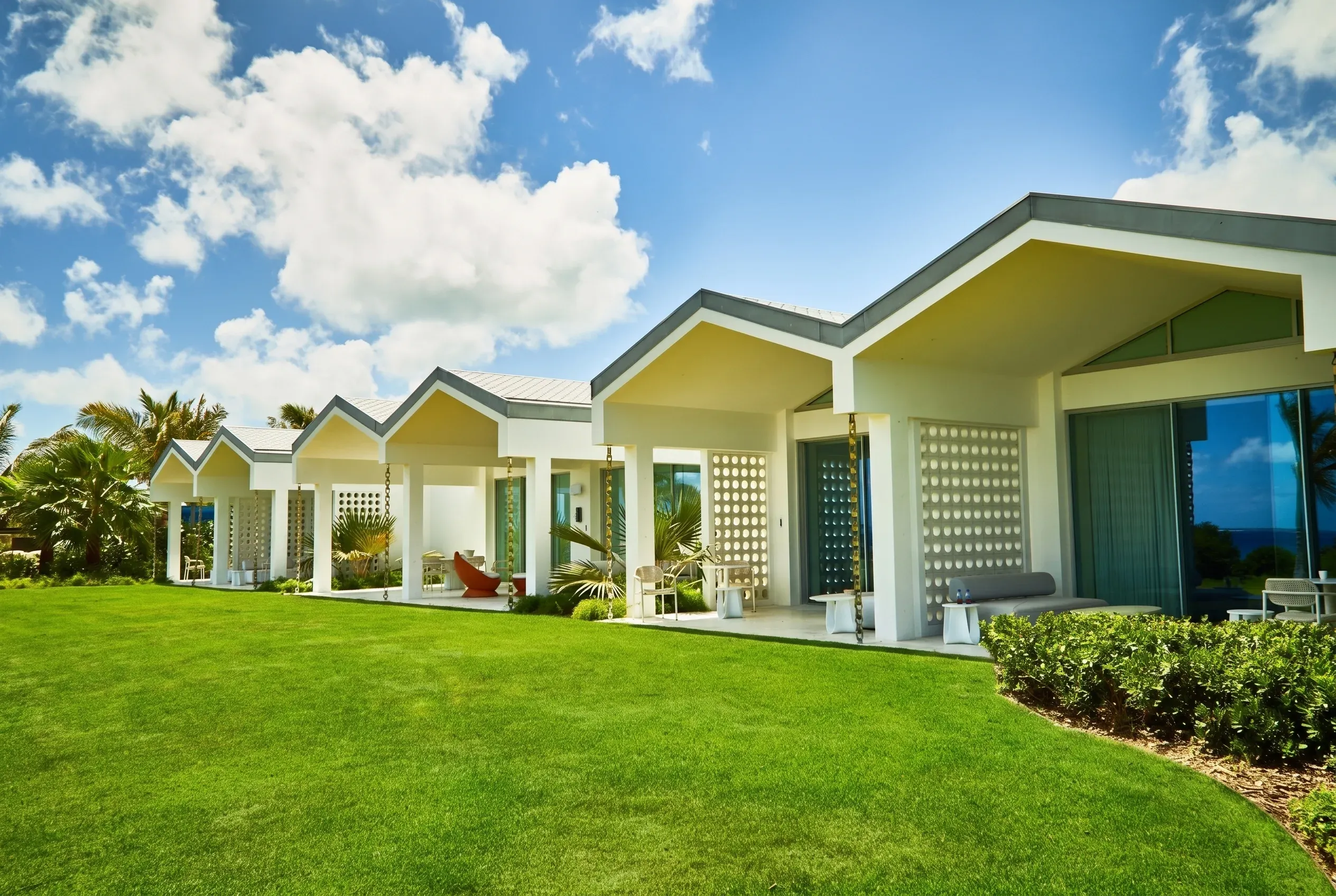 The guest lawn rolling toward the sea
