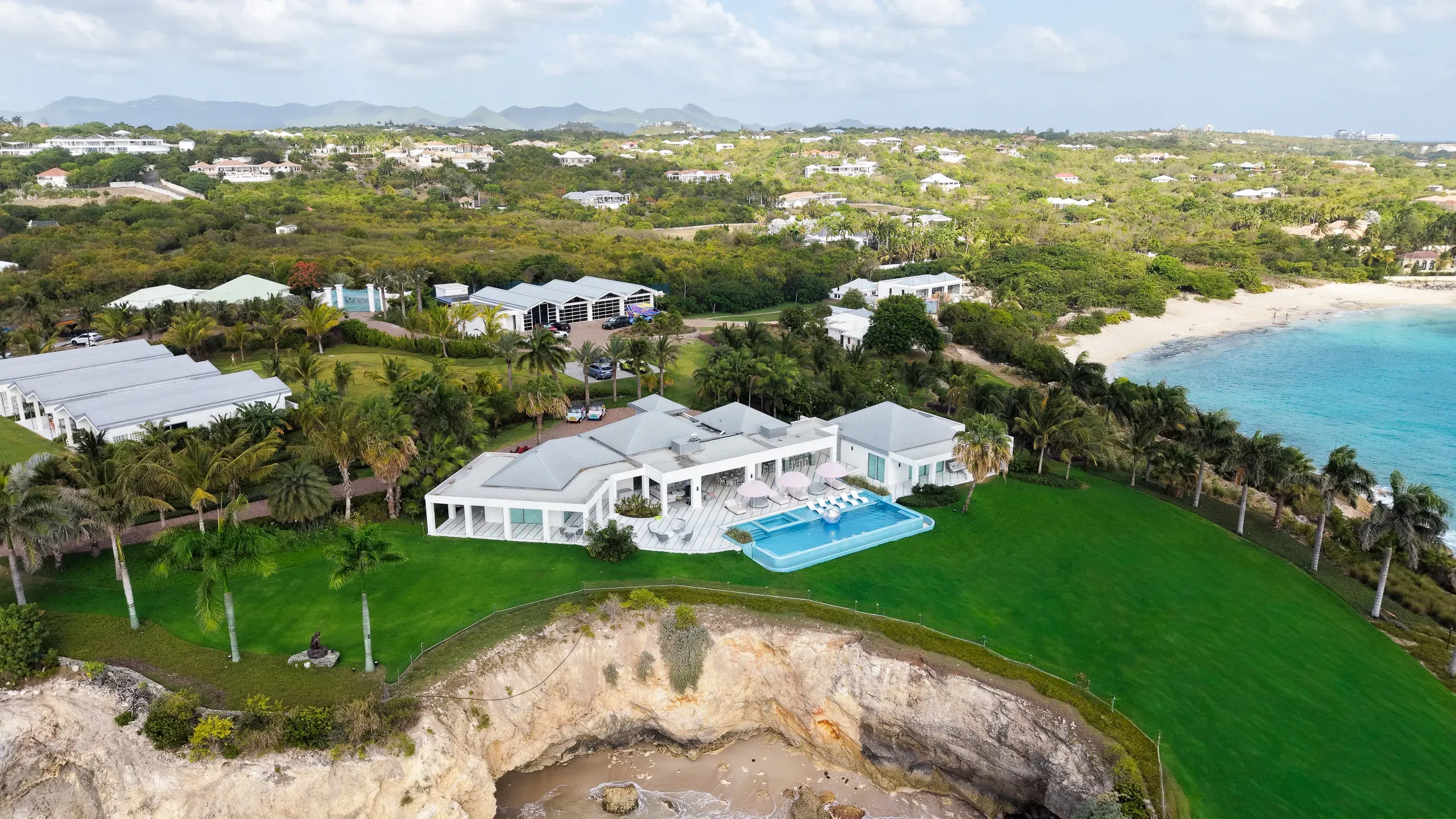 Queen B estate from above — the villa, lawns and private beach meeting the Caribbean