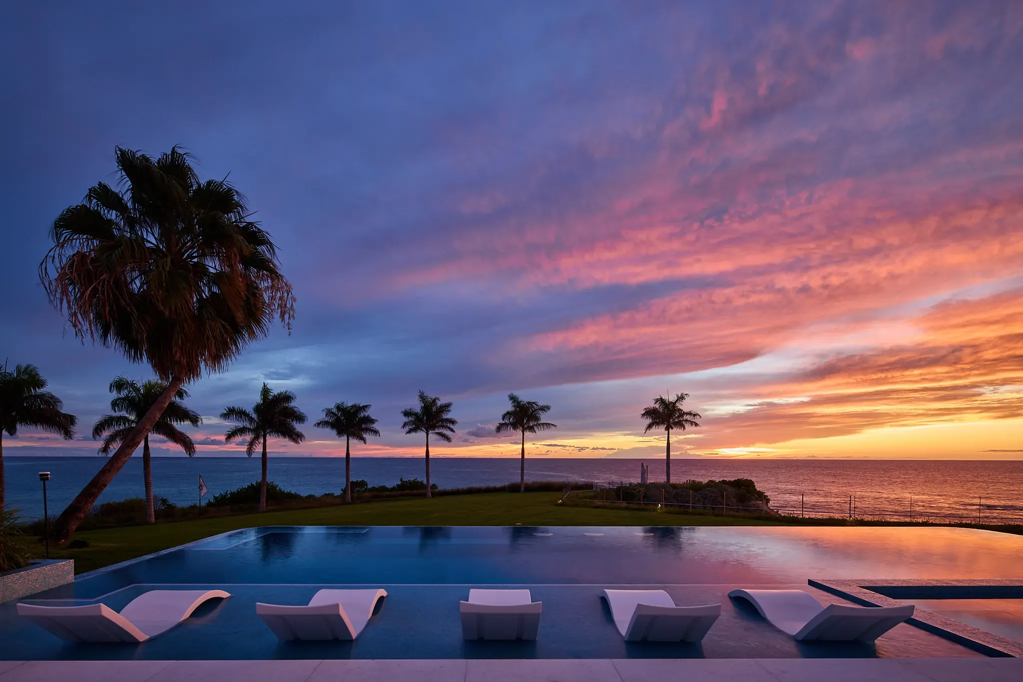 The pool terrace under a flaming Caribbean sunset