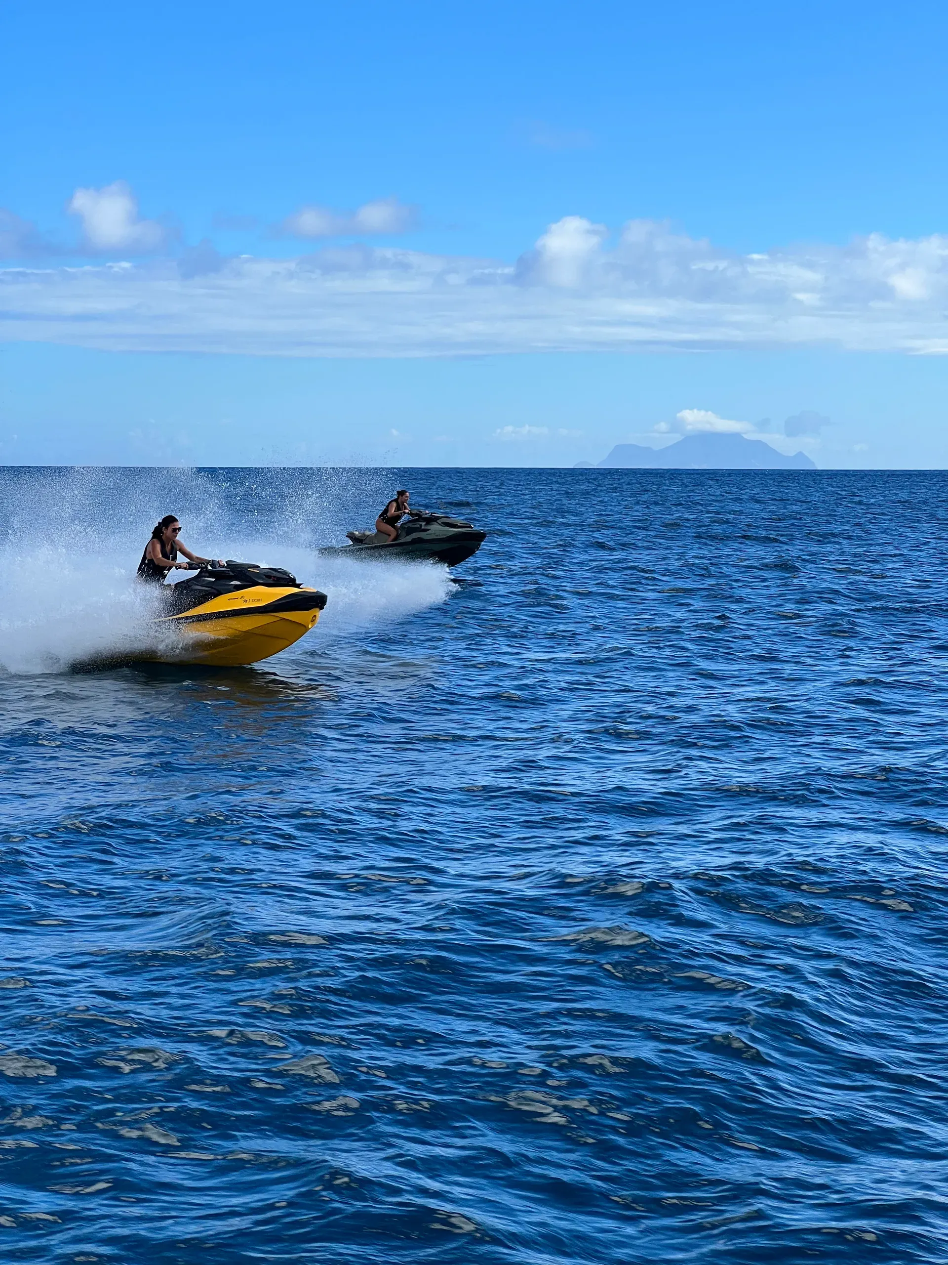 Two jet skis running side by side