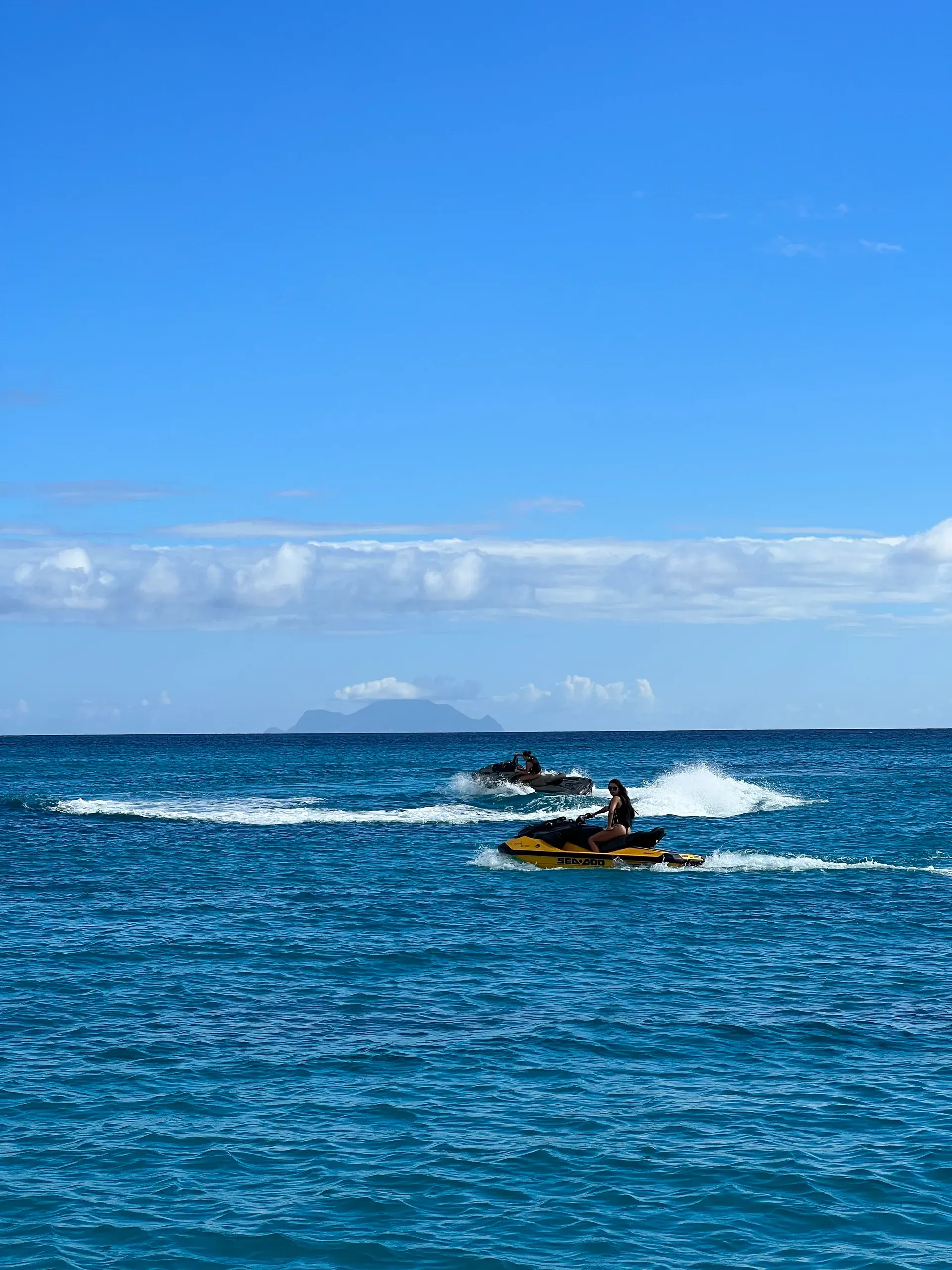 Jet skis over turquoise water