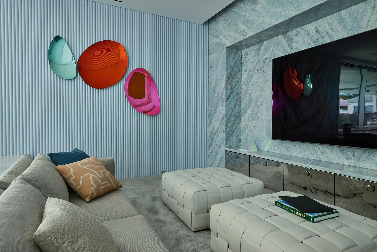 Media room with fluted walls and marble screen wall