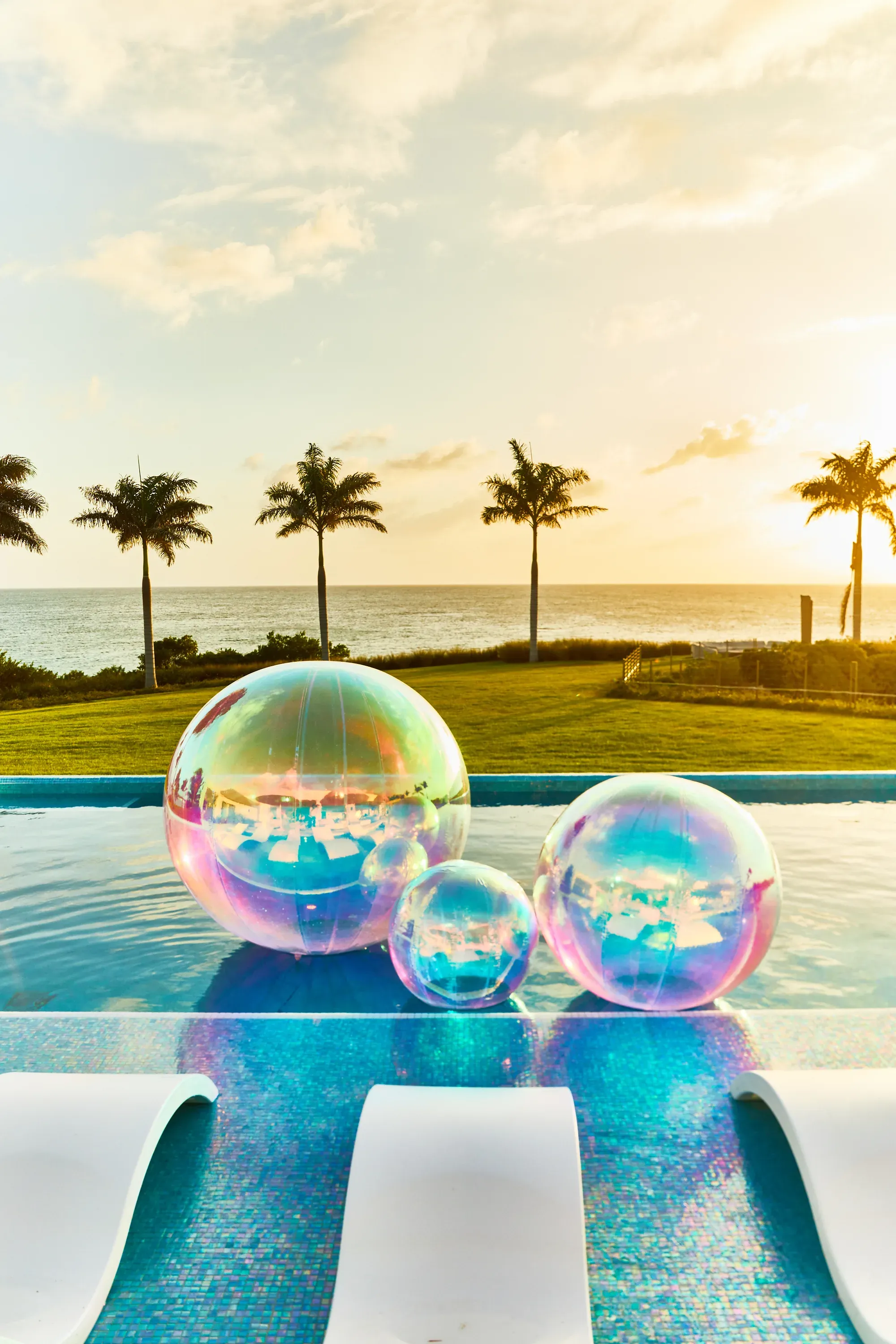 Iridescent spheres drifting on the cliff-edge pool